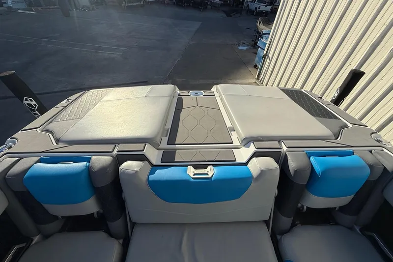 Slide: The Image of 2023 Malibu M240 boat interior with blue and gray seating, showcasing modern design. - 27