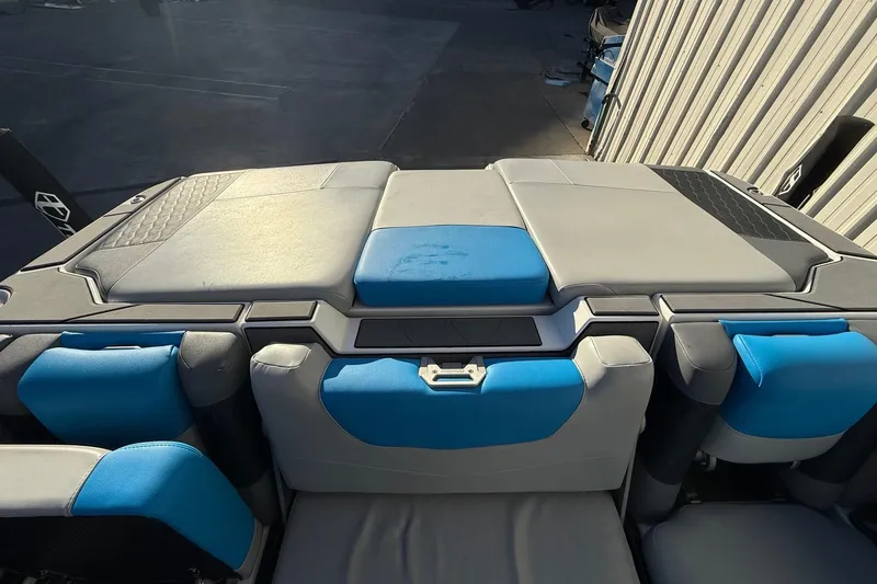 Slide: The Image of 2023 Malibu M240 boat interior with blue and gray seating, showcasing modern design. - 28