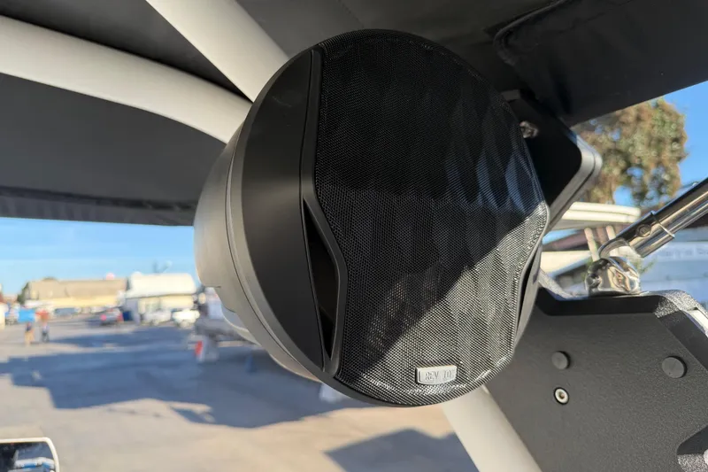 Slide: The Image of 2023 Malibu M240 boat speaker detail with outdoor background. - 33