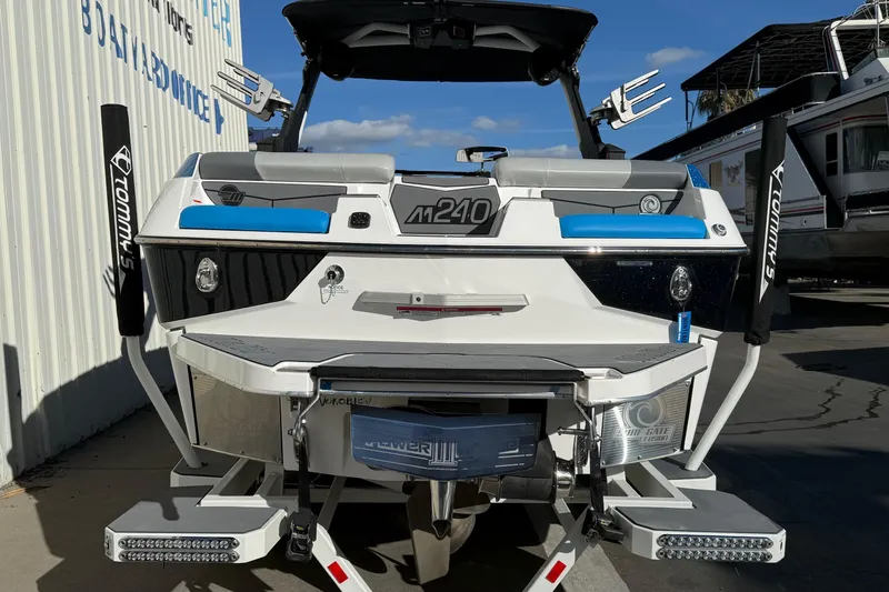 Slide: The Image of 2023 Malibu M240 boat rear view with sleek design and modern features. - 9