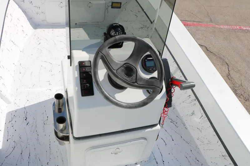 Slide: The Image of 2018 Mr. B's Boats 16 Skiff steering console with controls and compass. - 13