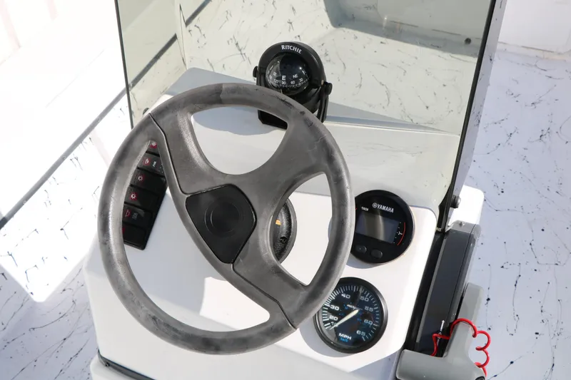 Slide: The Image of Steering console of 2018 Mr. B's Boats 16 Skiff with compass and gauges. - 18