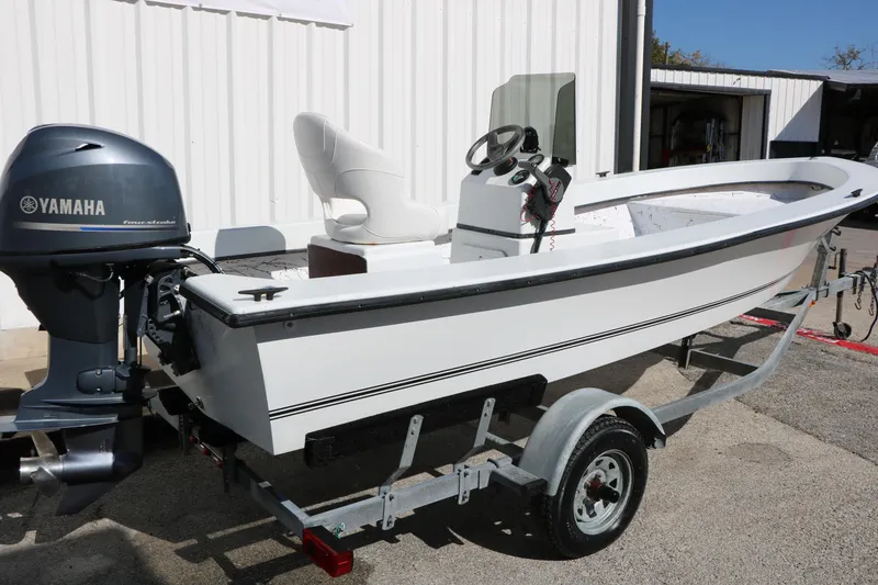 Slide: The Image of 2018 Mr. B's Boats 16 Skiff with Yamaha engine on trailer, parked outside. - 4