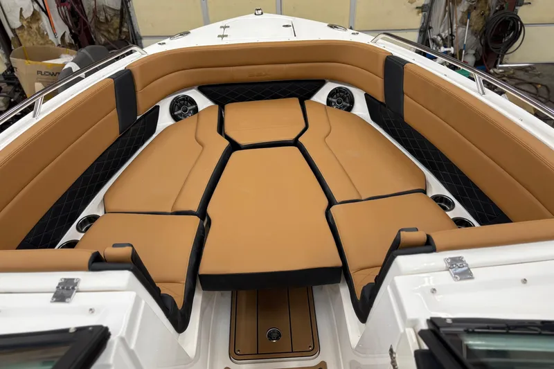 Slide: The Image of 2026 Chaparral 30 SSX boat interior with tan seating and black accents. - 13