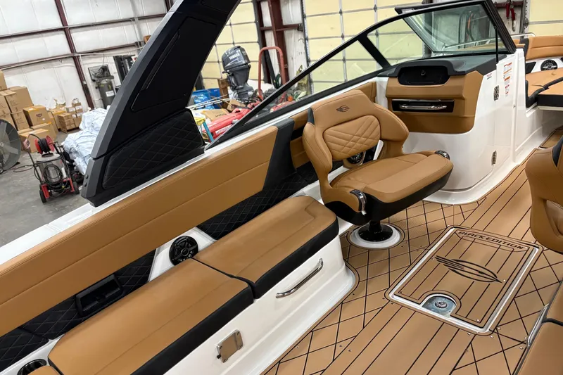 Slide: The Image of 2026 Chaparral 30 SSX boat interior with tan seating and sleek design. - 16