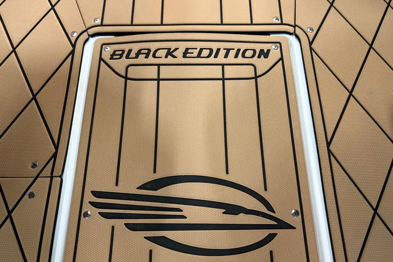 Slide: The Image of 2026 Chaparral 30 SSX Black Edition boat deck with logo and textured design. - 18