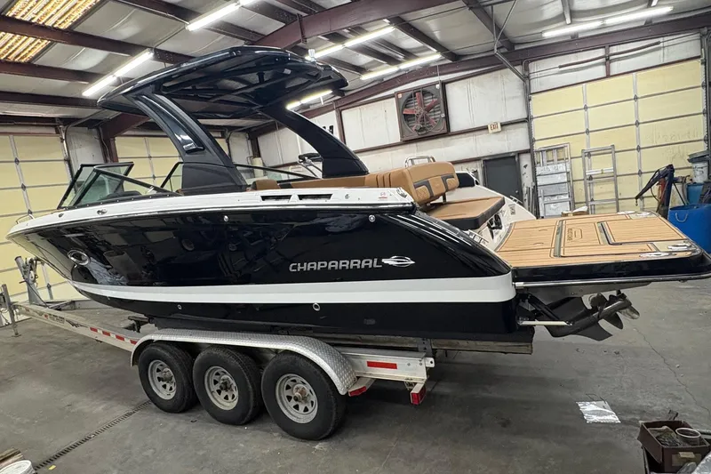 Slide: The Image of 2026 Chaparral 30 SSX boat on trailer in a warehouse setting. - 2