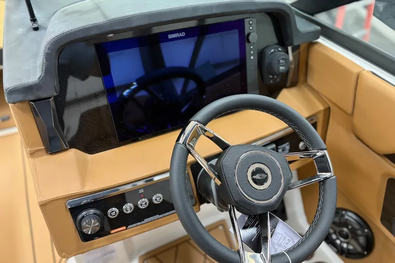 Slide: The Image of 2026 Chaparral 30 SSX boat dashboard with steering wheel and Simrad display. - 9