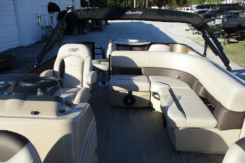 Slide: The Image of 2026 Bentley Pontoons Fish 200 4-Point interior with luxurious seating and steering console. - 12