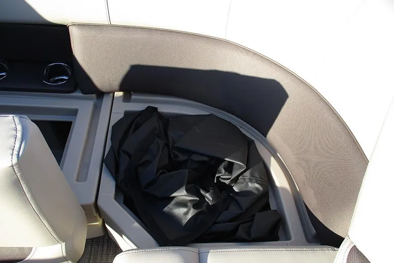 Slide: The Image of 2026 Bentley Pontoons Fish 200 4-Point interior storage compartment with black cover. - 16