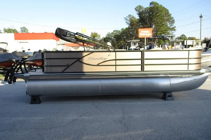 Slide: The Image of 2026 Bentley Pontoons Fish 200 4-Point pontoon boat in outdoor showroom. - 3