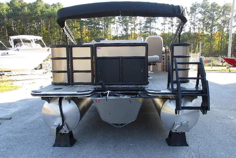 Slide: The Image of 2026 Bentley Pontoons Fish 200 4-Point pontoon boat, rear view, parked outdoors. - 6