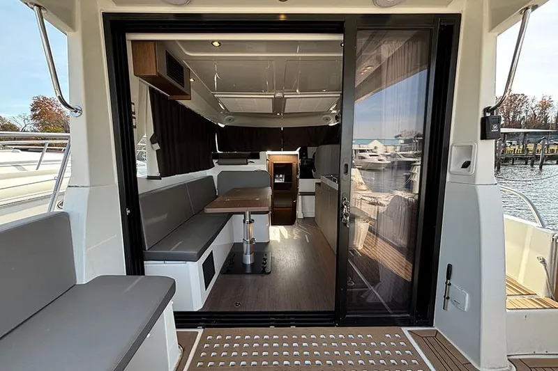 Slide: The Image of Interior view of 2023 Beneteau Antares 11 yacht, featuring modern seating and dining area. - 12