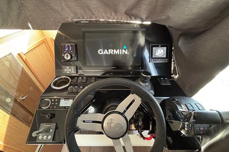 Slide: The Image of 2023 Beneteau Antares 11 helm with Garmin navigation system and modern controls. - 21