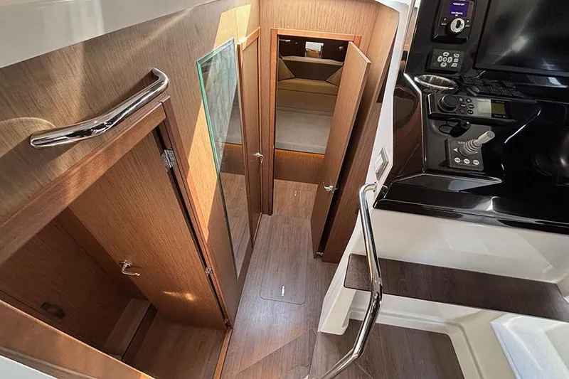 Slide: The Image of 2023 Beneteau Antares 11 interior with wood finish and modern controls. - 27