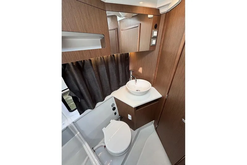 Slide: The Image of 2023 Beneteau Antares 11 bathroom with modern fixtures and wood accents. - 35