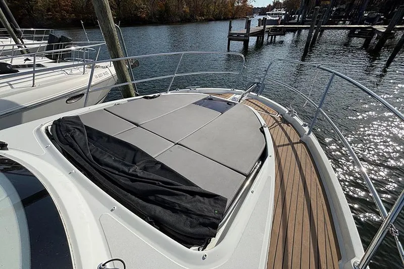 Slide: The Image of 2023 Beneteau Antares 11 boat deck with sunbathing area on calm water. - 5