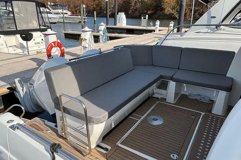 Slide: The Image of 2023 Beneteau Antares 11 boat with spacious seating area at the dock. - 9