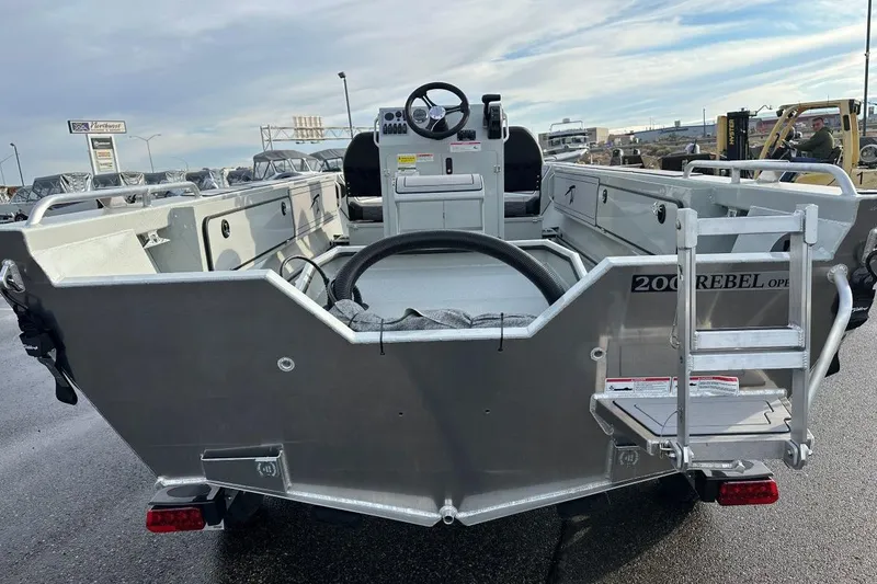 Slide: The Image of 2026 Weldcraft 200 Rebel Open CC boat, rear view, showcasing open deck and steering console. - 4
