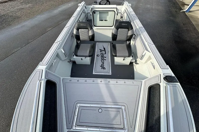 Slide: The Image of 2026 Weldcraft 200 Rebel Open CC boat interior with seating and console. - 7