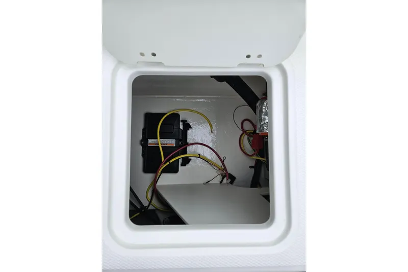 Slide: The Image of 2025 Chaparral 21 SSi boat battery compartment with wiring and connections. - 8