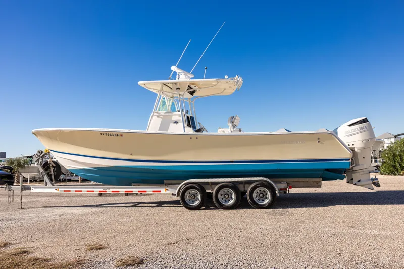 Slide: The Image of 2005 Regulator 32 Classic boat on trailer under clear blue sky. - 11