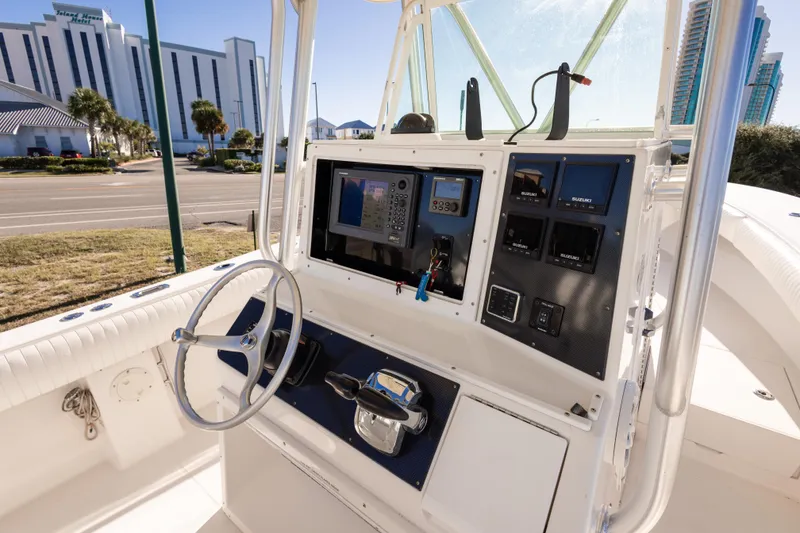 Slide: The Image of 2005 Regulator 32 Classic boat dashboard with steering wheel and navigation controls. - 17