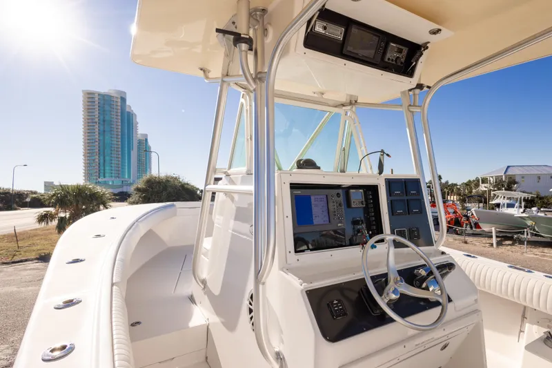 Slide: The Image of 2005 Regulator 32 Classic boat dashboard with cityscape background under clear blue sky. - 18