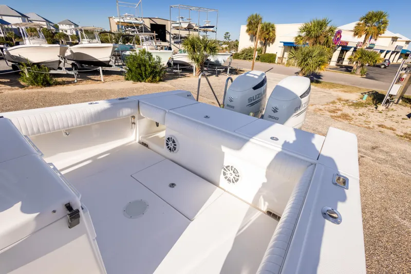 Slide: The Image of 2005 Regulator 32 Classic boat with twin Suzuki engines, docked outdoors. - 26