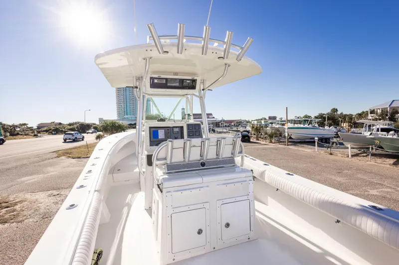 Slide: The Image of 2005 Regulator 32 Classic boat with helm station, parked under clear blue sky. - 27