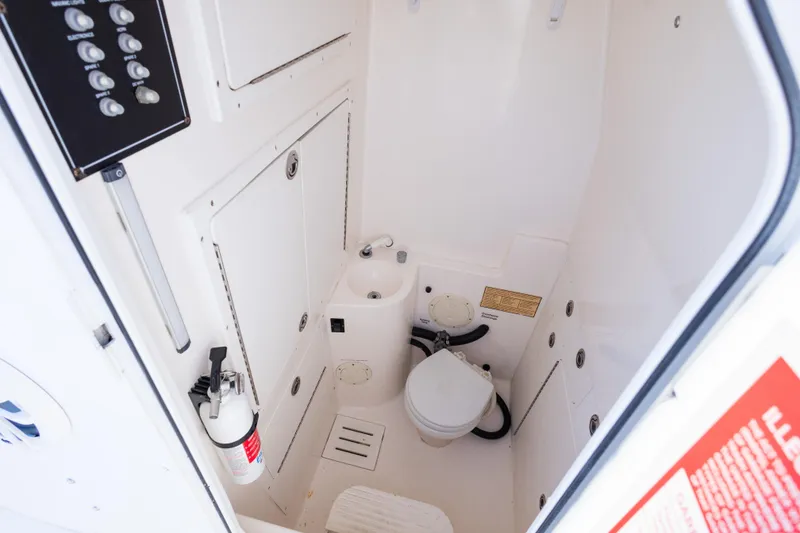 Slide: The Image of 2005 Regulator 32 Classic boat interior with toilet and control panel. - 28