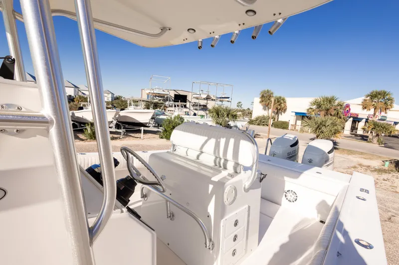 Slide: The Image of 2005 Regulator 32 Classic boat interior with steering wheel and dual Suzuki engines. - 31