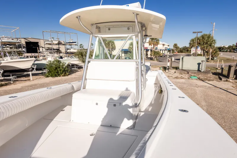 Slide: The Image of 2005 Regulator 32 Classic boat with white seating and T-top in a marina setting. - 33