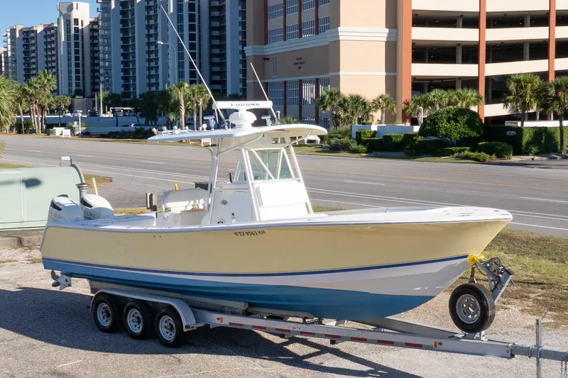 Slide: The Image of 2005 Regulator 32 Classic boat on trailer, parked near urban buildings. - 4