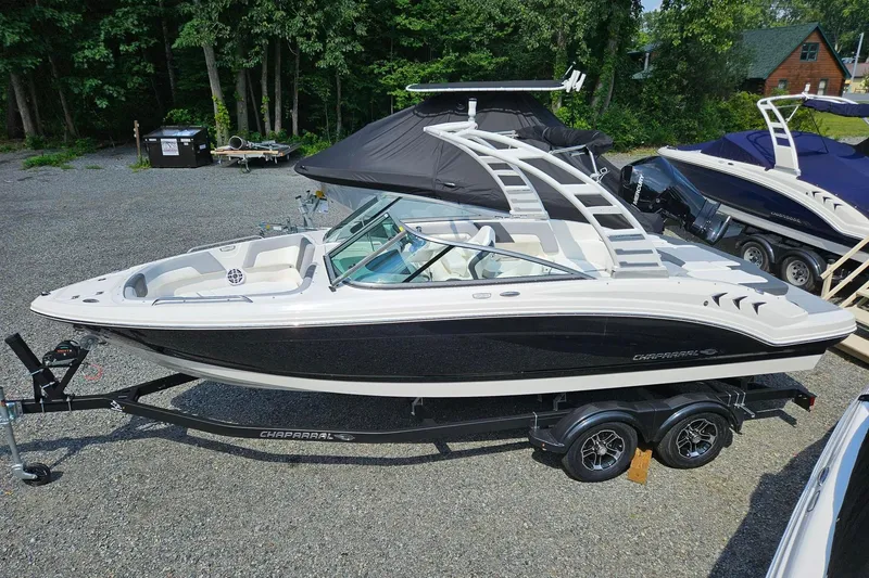 The Image of 2025 Chaparral 23 SSi boat on trailer, sleek design, parked outdoors. - 0
