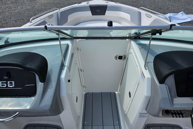 Slide: The Image of 2025 Chaparral 23 SSi boat interior with seating and control panel. - 13