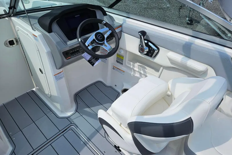 Slide: The Image of 2025 Chaparral 23 SSi boat cockpit with modern steering and controls. - 14