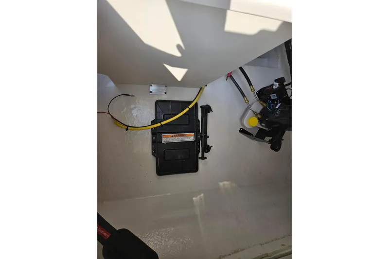 Slide: The Image of 2025 Chaparral 23 SSi boat interior showing wiring and mechanical components. - 17