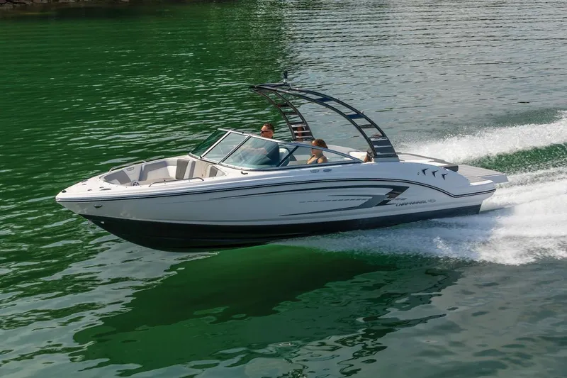 Slide: The Image of Manufacturer Provided Image: 2025 Chaparral 23 SSi speedboat cruising on green water, showcasing sleek design and performance. - 20