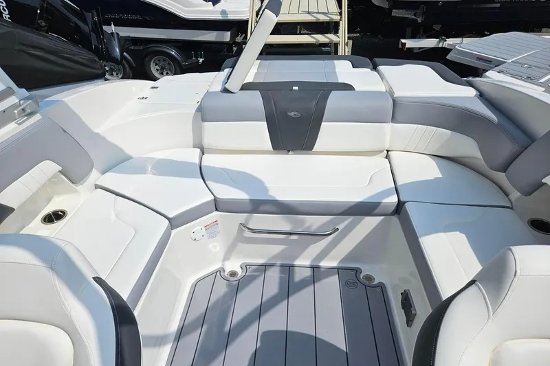 Slide: The Image of 2025 Chaparral 23 SSi boat interior with white and gray seating arrangement. - 4