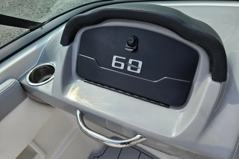 Slide: The Image of 2025 Chaparral 23 SSi boat dashboard with cup holder and handle. - 6