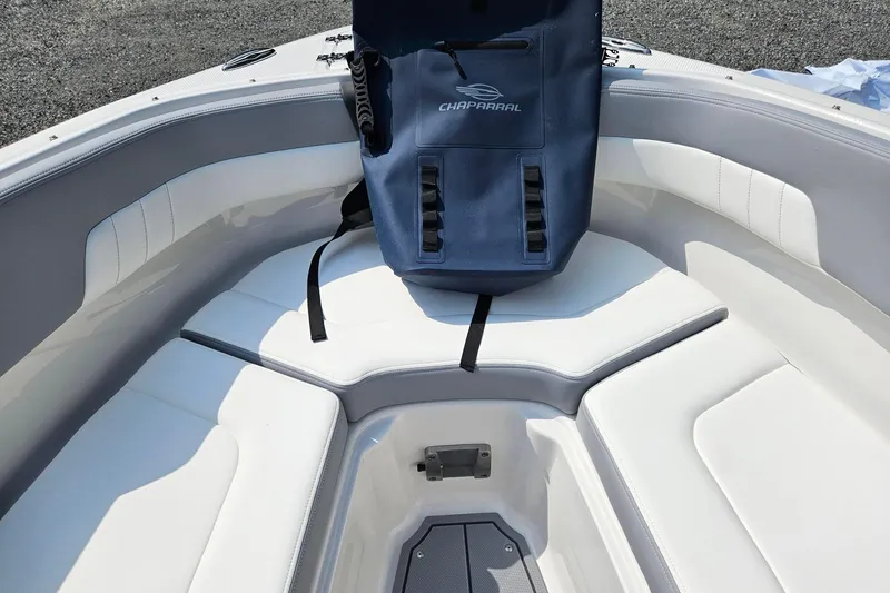 Slide: The Image of 2025 Chaparral 23 SSi boat interior with white seating and blue Chaparral bag. - 9