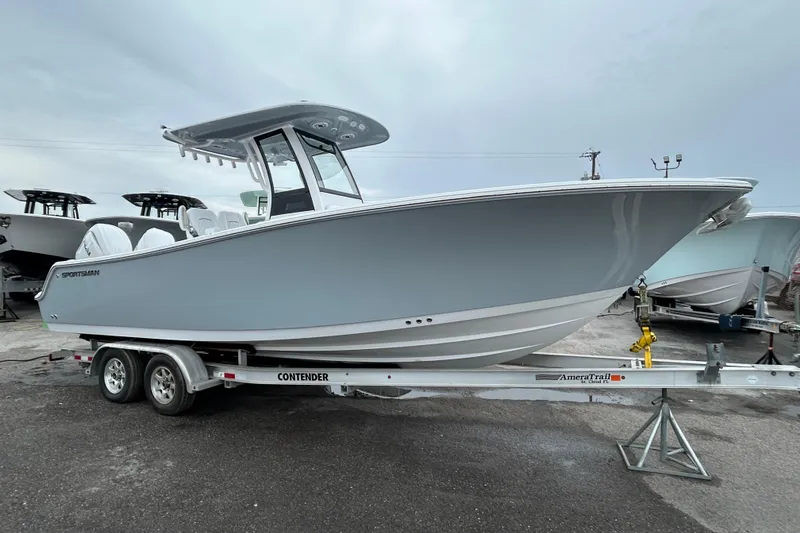 The Image of 2026 Sportsman Open 252 Center Console boat on trailer, displayed outdoors. - 1