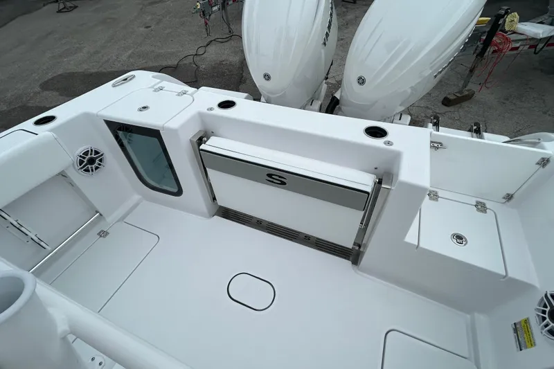 Slide: The Image of 2026 Sportsman Open 252 Center Console boat deck with dual engines and storage compartments. - 10