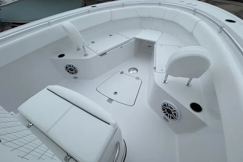 Slide: The Image of 2026 Sportsman Open 252 Center Console boat interior with white seating and speakers. - 12