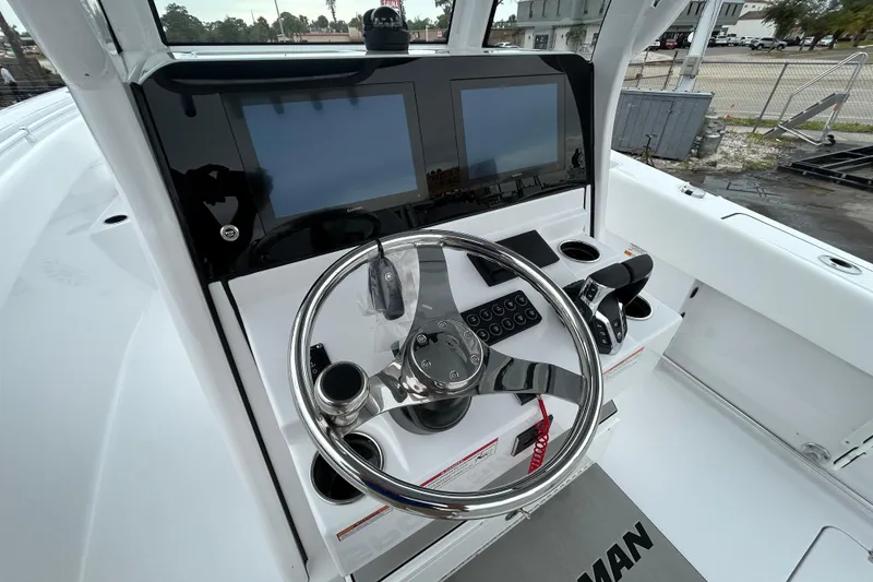 Slide: The Image of 2026 Sportsman Open 252 Center Console dashboard with dual screens and steering wheel. - 18