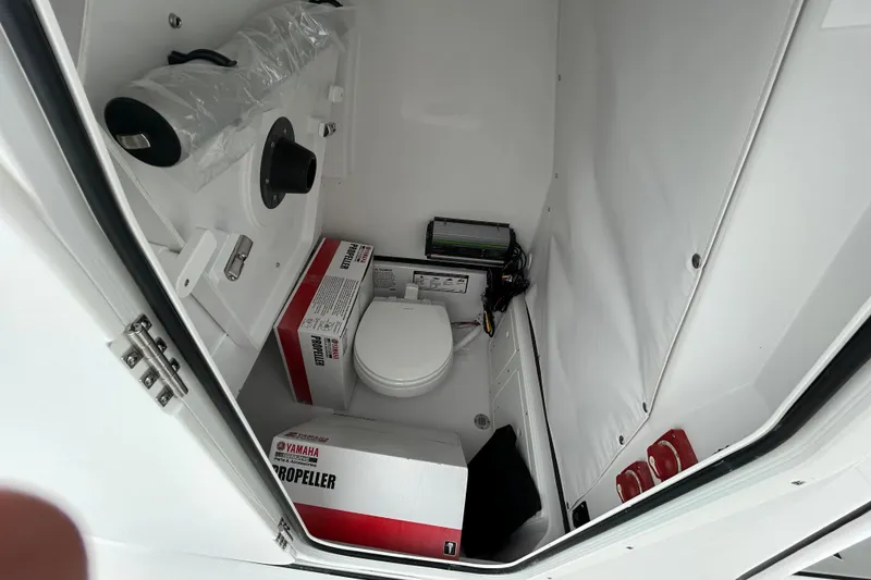 Slide: The Image of 2026 Sportsman Open 252 Center Console interior with toilet and Yamaha propeller boxes. - 20