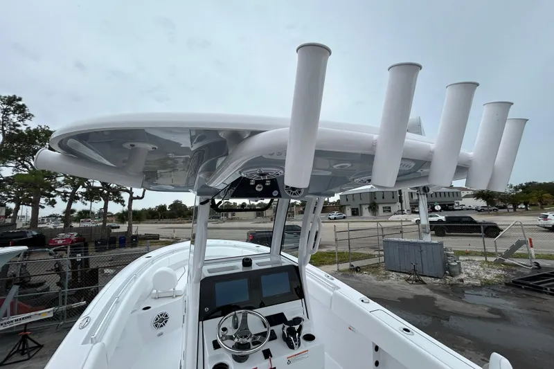 Slide: The Image of 2026 Sportsman Open 252 Center Console boat with advanced helm and rod holders. - 22