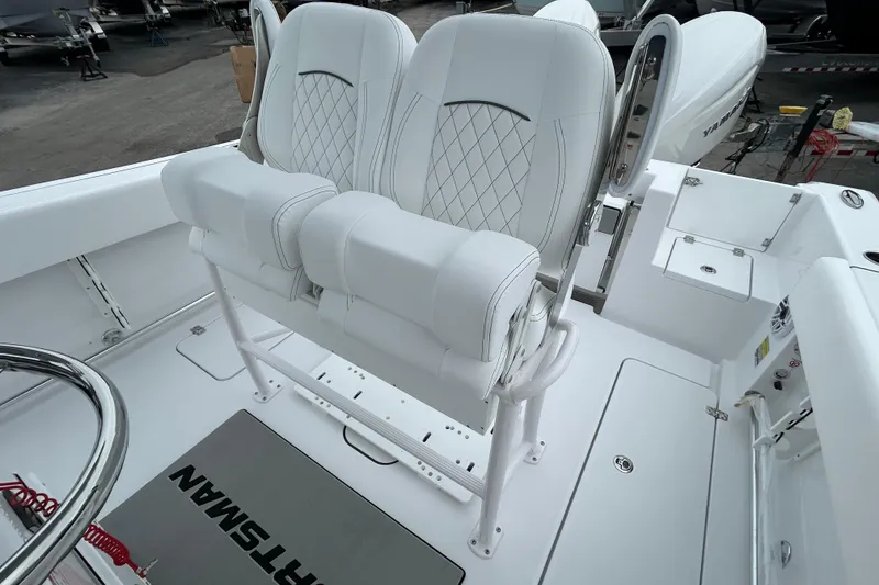 Slide: The Image of 2026 Sportsman Open 252 Center Console boat interior with white seating and console. - 9