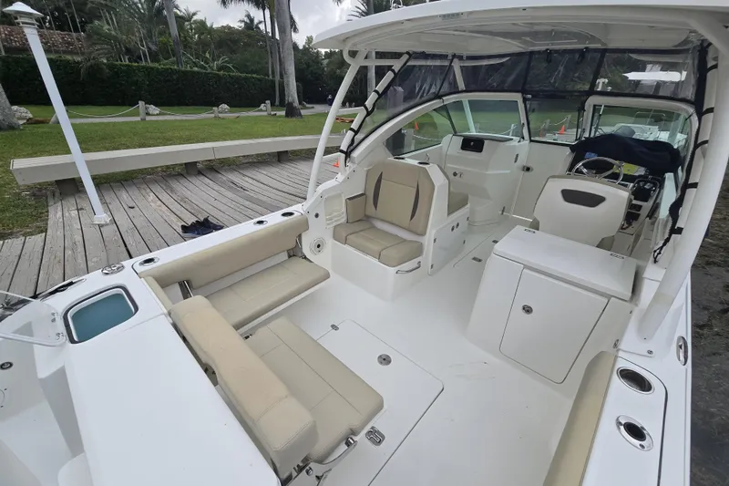 Slide: The Image of 2020 Pursuit DC 266 Dual Console interior with open storage compartment and seating. - 13